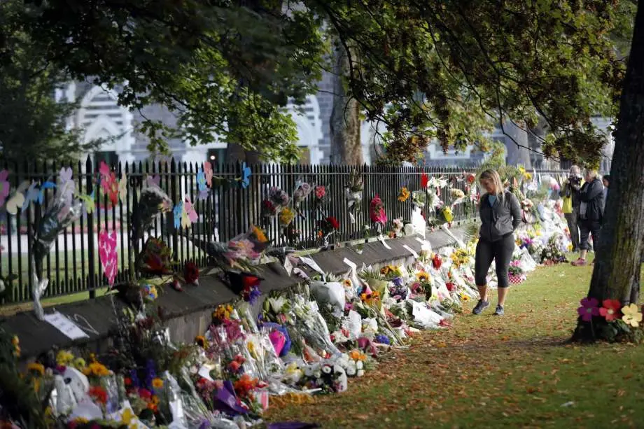 Mourners paying their respects at a makeshift memorial at the Botanical Gardens in Christchurch, New Zealand, Saturday, March 16, 2019.
