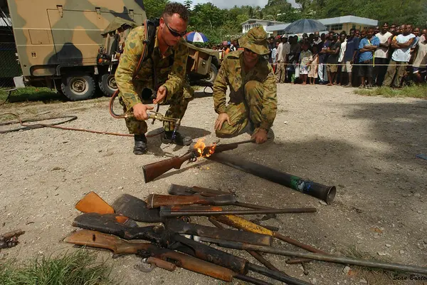 Members of RAMSI military destroy surrendered weapons, west Honiara, Solomon Islands, 2003.