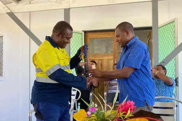 Mr Ricky George hands over keys to Mr Patterson Lusi of MFMR.
