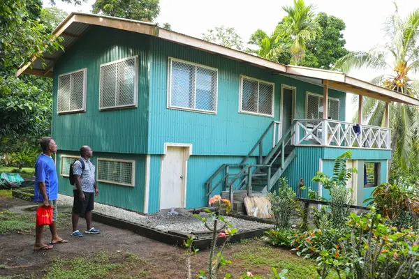 Permanent Secretary of MRD Dr. Samson Viulu and a tour guide check one of the houses fully funded by CDF at Nyialo village.