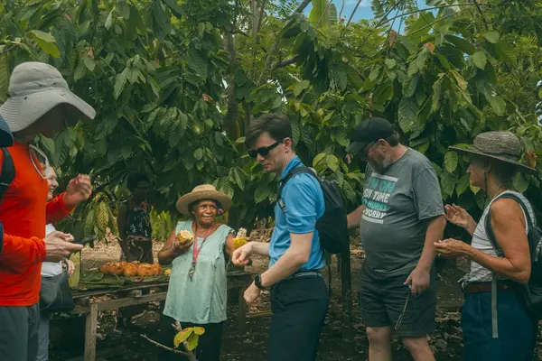 Grace Fekau giving visitors fresh cocoa beans to try from the Amazing Grace Cocoa trees.