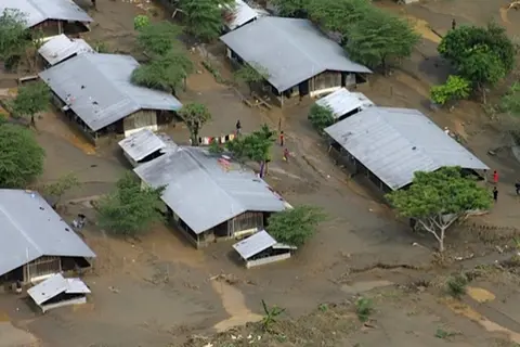 Homes are surrounded by mud and flood waters on the Guadalcanal Plains, Solomon Islands.