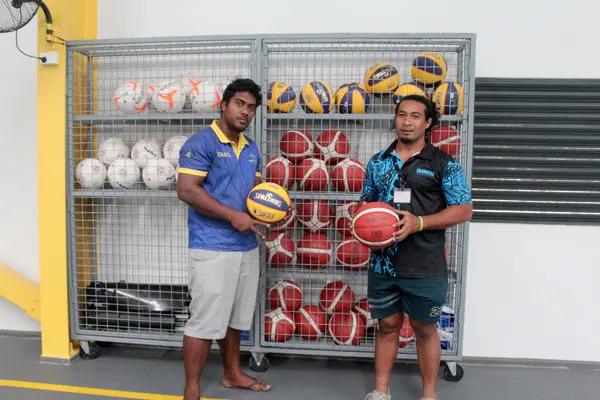 Volleyball coach on scholarship Nigel and SINIS S&C coach Tony Taupongi displaying the new set of basketball balls.