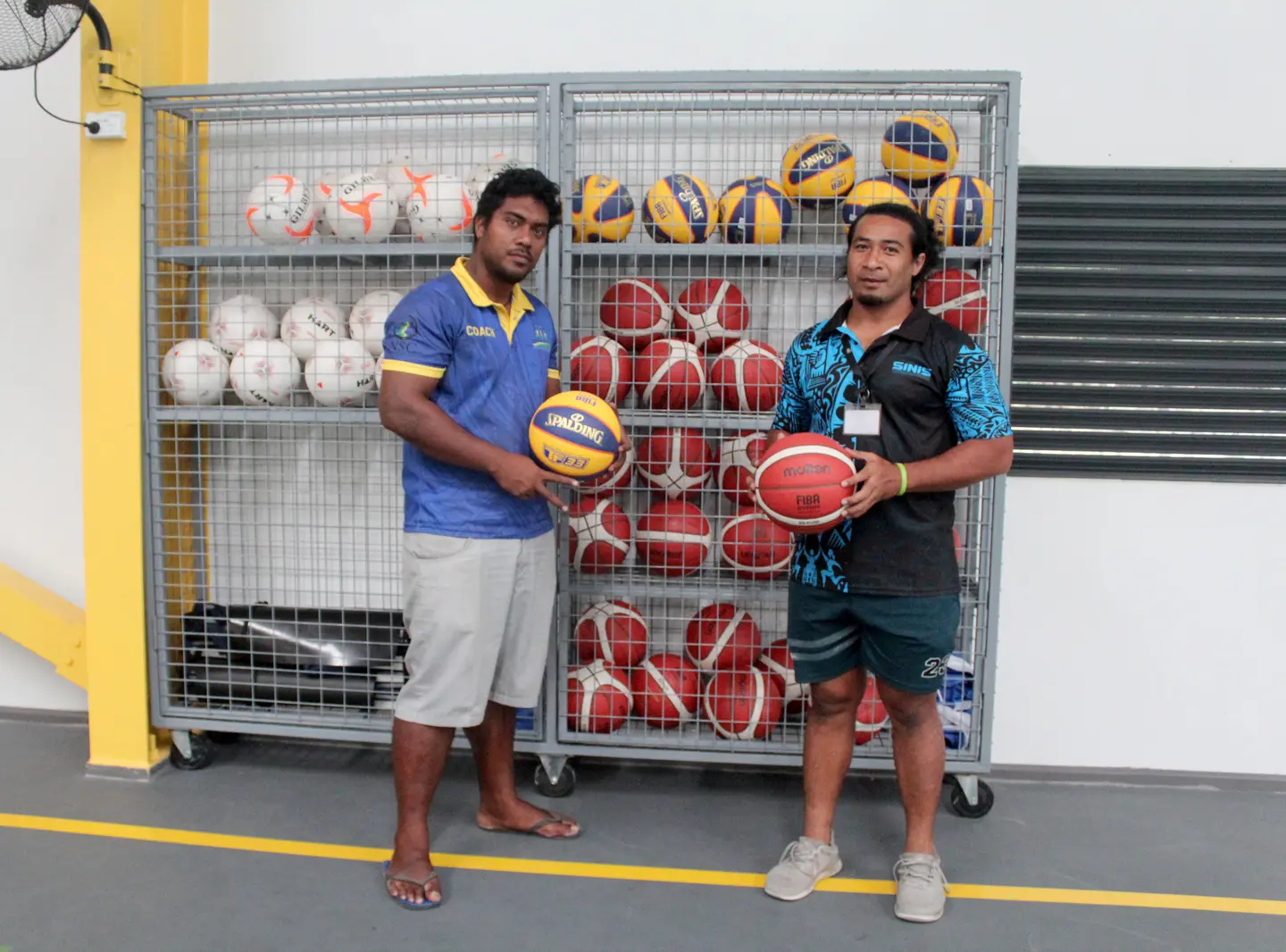 Volleyball coach on scholarship Nigel and SINIS S&C coach Tony Taupongi displaying the new set of basketball balls.