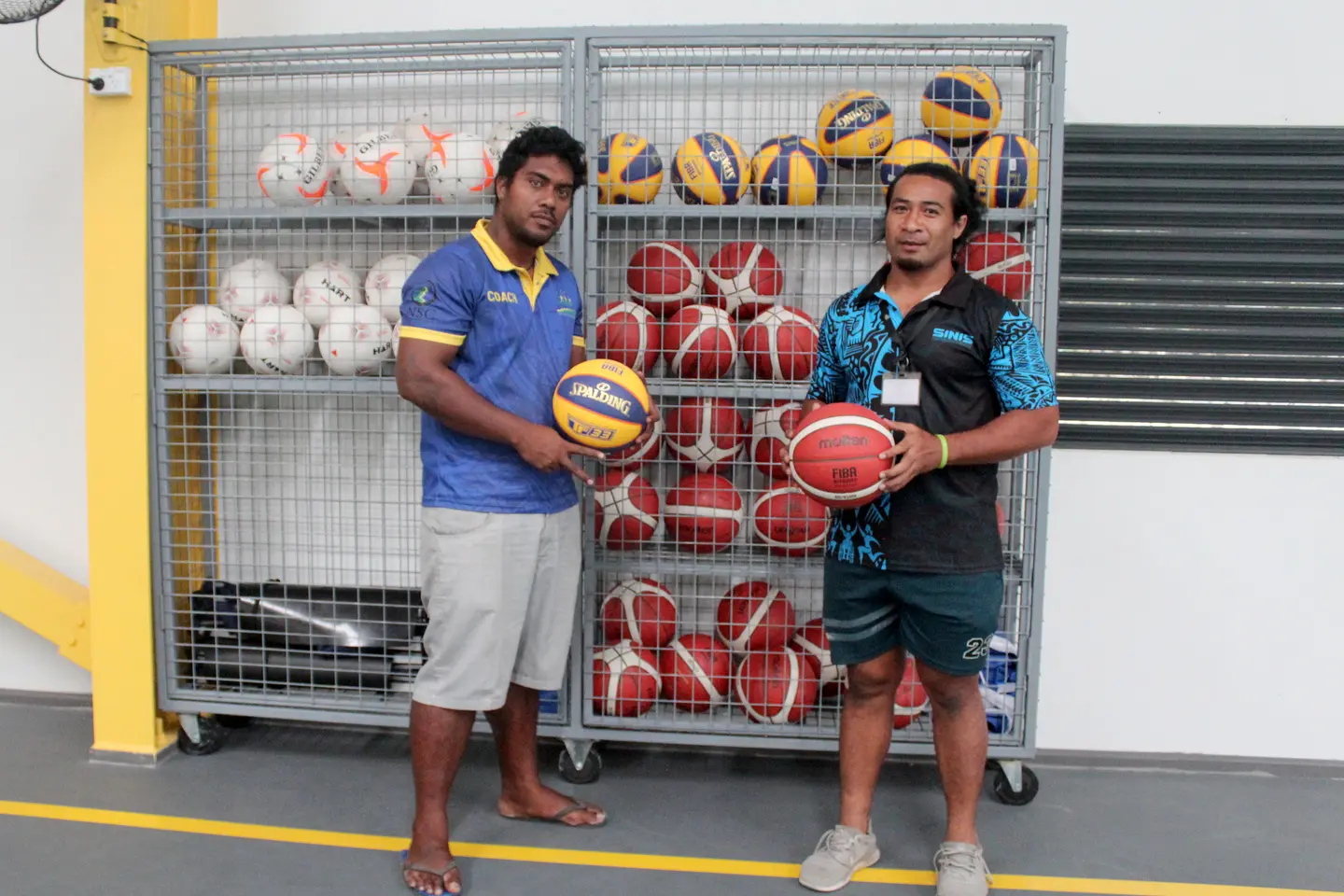 Volleyball coach on scholarship Nigel and SINIS S&C coach Tony Taupongi displaying the new set of basketball balls.