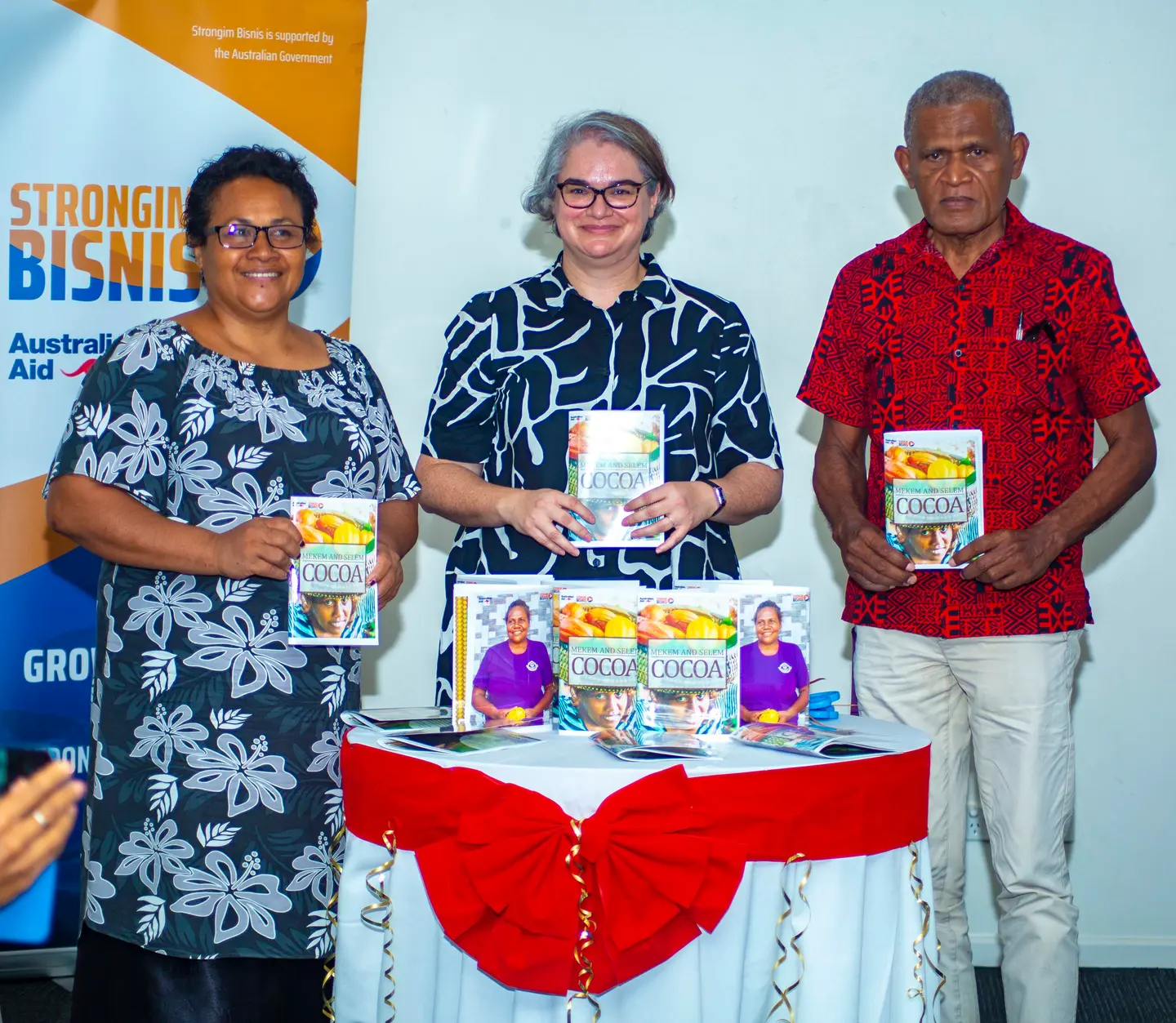 Launching the book “Mekim and Selem Cocoa”. (L to R): Permanent Secretary for the Ministry of Agriculture and Livestock, Ethel Frances; Deputy Australian High Commissioner to Solomon Islands, Sally-Anne Vincent; and Director of Solomon Islands Association of Rural Training Centres, Billy Mae.