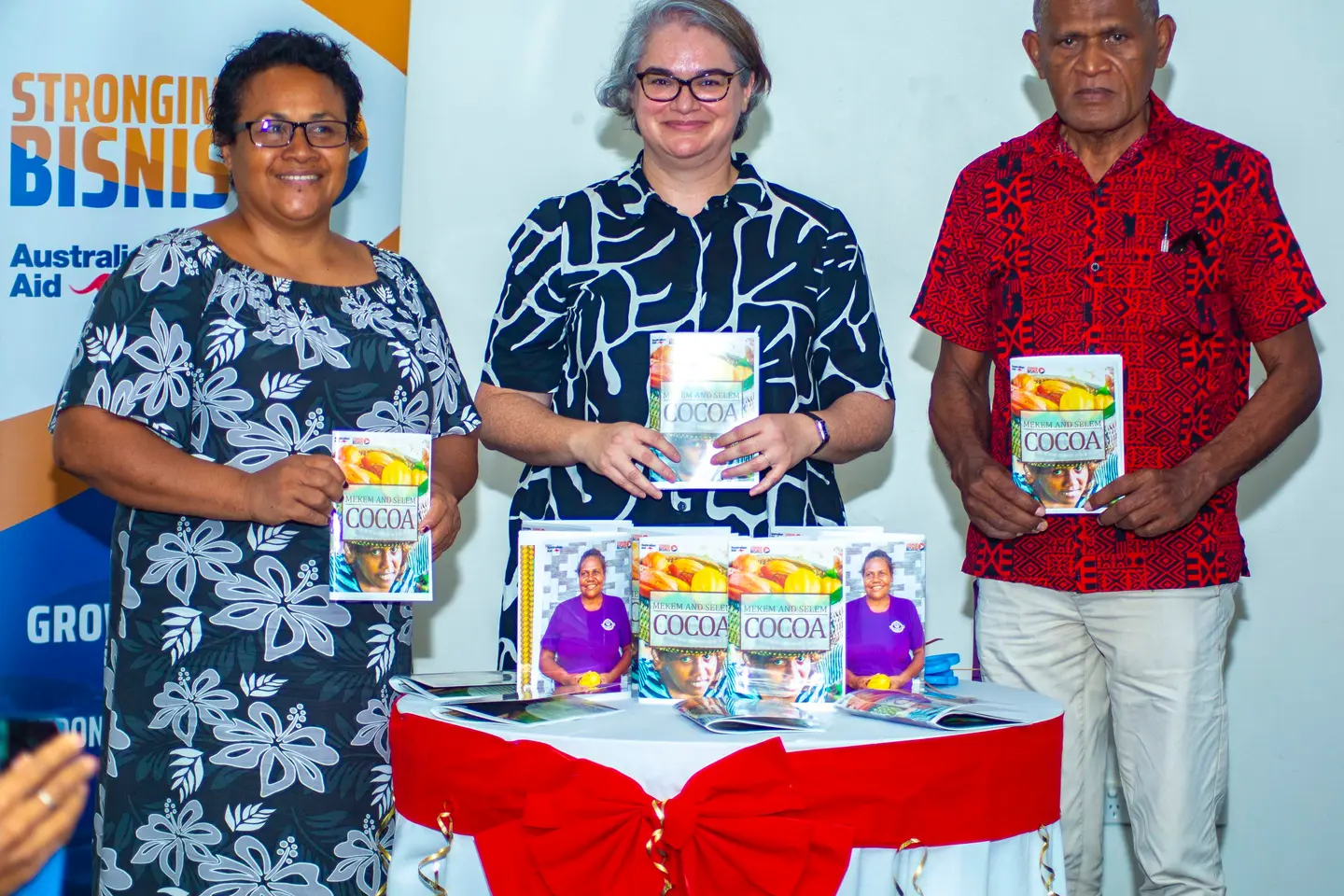 Launching the book “Mekim and Selem Cocoa”. (L to R): Permanent Secretary for the Ministry of Agriculture and Livestock, Ethel Frances; Deputy Australian High Commissioner to Solomon Islands, Sally-Anne Vincent; and Director of Solomon Islands Association of Rural Training Centres, Billy Mae.