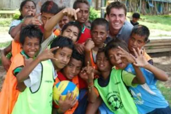 Australian High Commission Third Secretary, William Ewing, with young volleyball players in Gizo, Western Province.