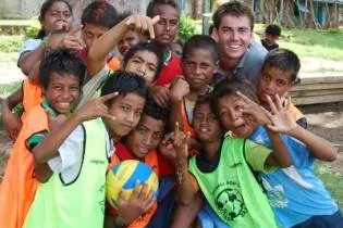 Australian High Commission Third Secretary, William Ewing, with young volleyball players in Gizo, Western Province.