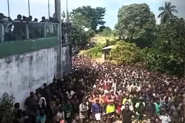 The crowd that gathered outside the motel used by the Opposition group.