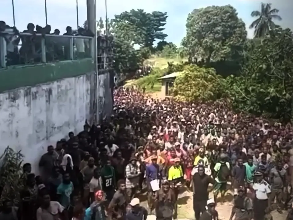 The crowd that gathered outside the motel used by the Opposition group.