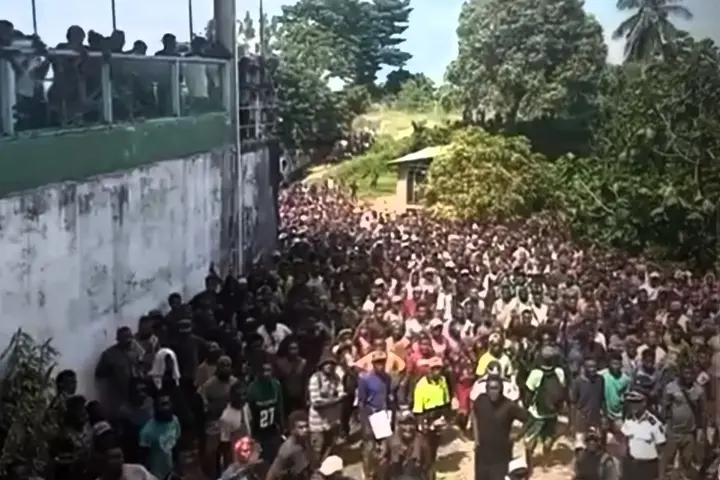 The crowd that gathered outside the motel used by the Opposition group.