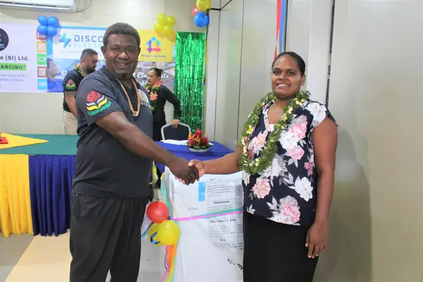 Mrs. Pricilla Lole receiving her product from a SPBD representative.