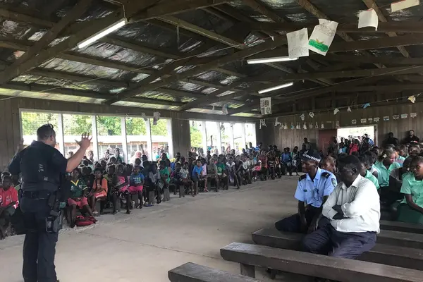 A PRT officer addressing a large crowd at Ringgi.
