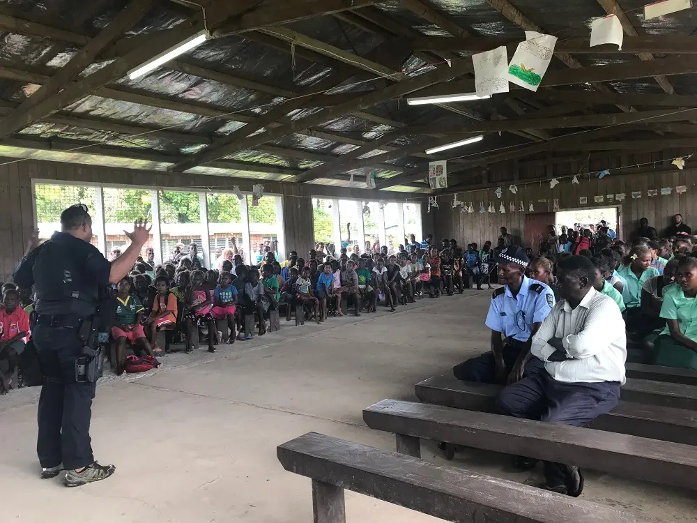 A PRT officer addressing a large crowd at Ringgi.