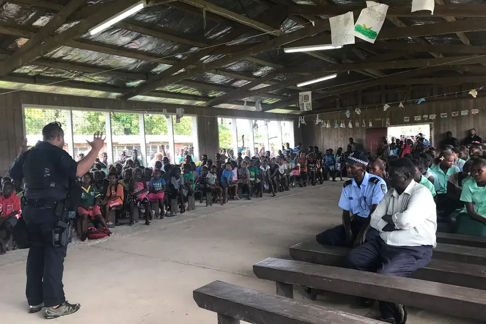 A PRT officer addressing a large crowd at Ringgi.