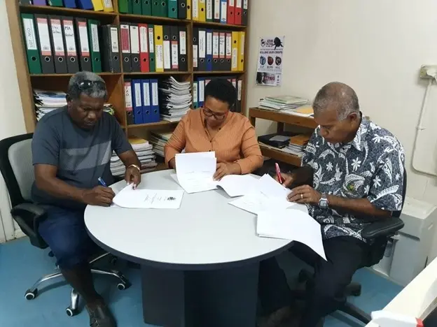 Mr Tony Tepeaihana, Managing Director of Food Works Supplies Ltd, MAL Permanent Secretary Mrs Ethel Tebengi Frances and MAL Undersecretary Technical Michael Ho’ota signing the funding agreement.