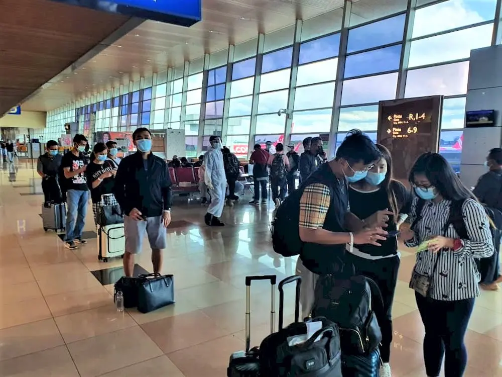 The group of 68 Malaysians upon their arrival at the Kuching International Airport before they were taken to the quarantine centres, March 16, 2021.