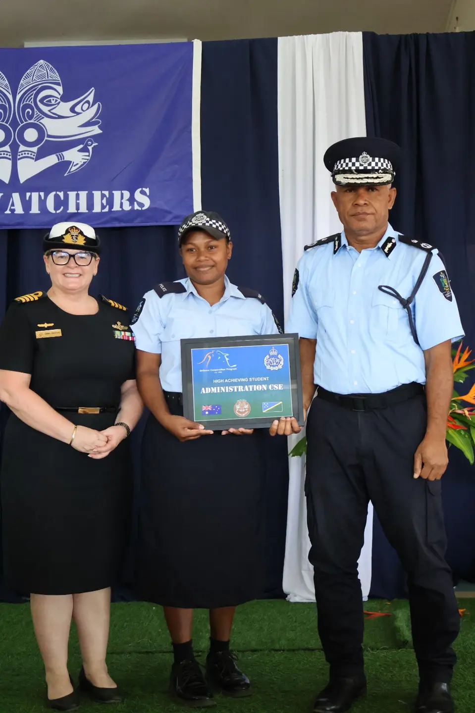 PC Bethy Panai Nai receives the High Achieving Student award for the inaugural Administration Course from Acting Commissioner RSIPF James Aitorea and Australian Defence Advisor Captain Emma Griffiths.