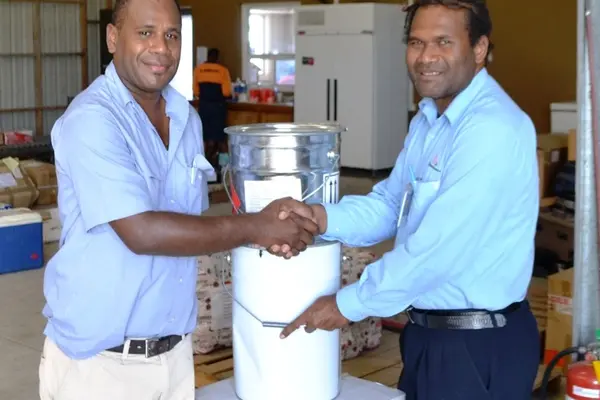 The buckets of paint were handed over to the President of the Rotary Club Sebastian Ilala (left).