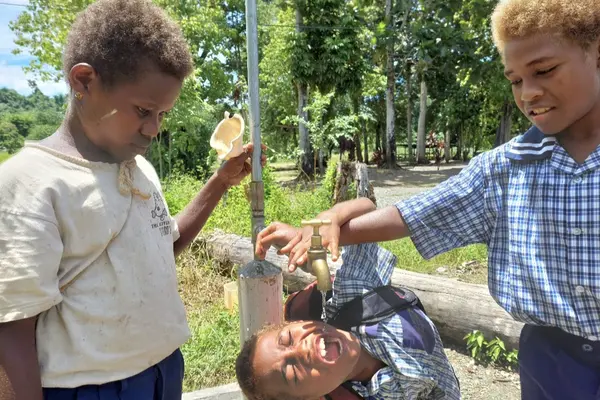 These students are now able to access safe drinking water from the school standpipe, provided by the CBSP water supply program.