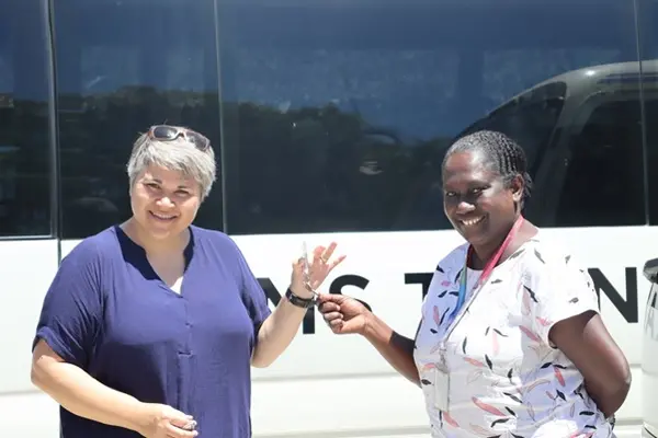 NZ High Commissioner, Her Excellency Georgina Roberts hands over keys of the buses to Health PS Mrs. Pauline McNeil.
