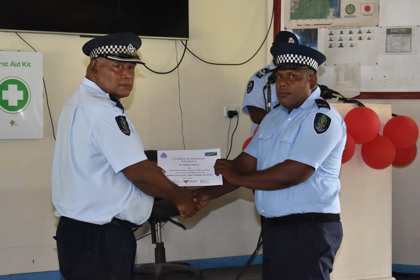 Supervising Assistant Commissioner, National Operations Russel Tagini presenting certificate of Attainment to Constable Bonsy Paolo.
