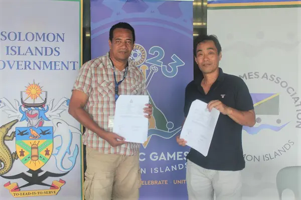 Adrian Tuhanuku, Senior Sport Delivery Manager at the 2023 Games Organizing Committee (GOC) and President of the Solomon Islands Weightlifting Federation, Naoyuki Fujiyama after signing of the first funding agreement with the GOC.