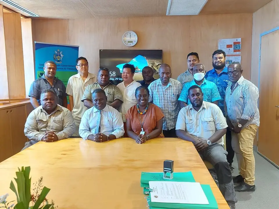 Group photo of Permanent Secretaries Finance and Treasury & Health and Medical Services with officials and the managing directors of companies that were awarded the job to construct the AHCs and RHCs.