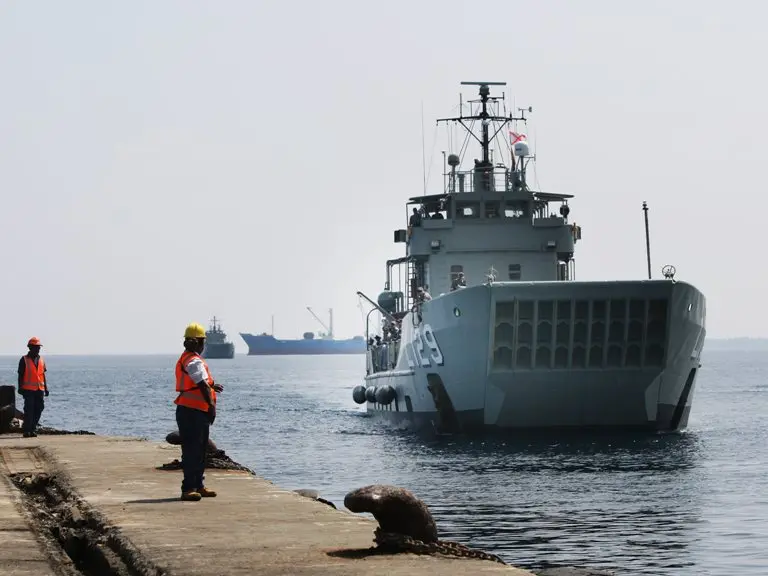 HMAS Tarakan, followed by HMAS Labuan, prepares to berth in Honiara, Solomon Islands for Operation Render Safe 2013.