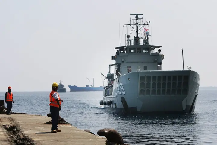 HMAS Tarakan, followed by HMAS Labuan, prepares to berth in Honiara, Solomon Islands for Operation Render Safe 2013.
