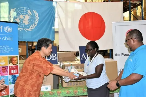 His Excellency Morimoto Yasuhiro, Japanese Ambassador to Solomon Islands handing over some of the Japanese funded PPEs to the Permanent Secretary of the Ministy of Health Mrs. Pauline McNeil, in front of Dr. Zelalem Taffesse, Chief of UNICEF Solomon Islands Field Office.