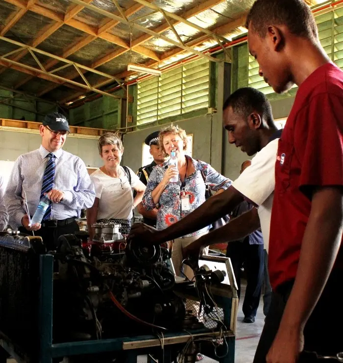 A mechanics student provides a demonstration to AusAID Director General Peter Baxter.