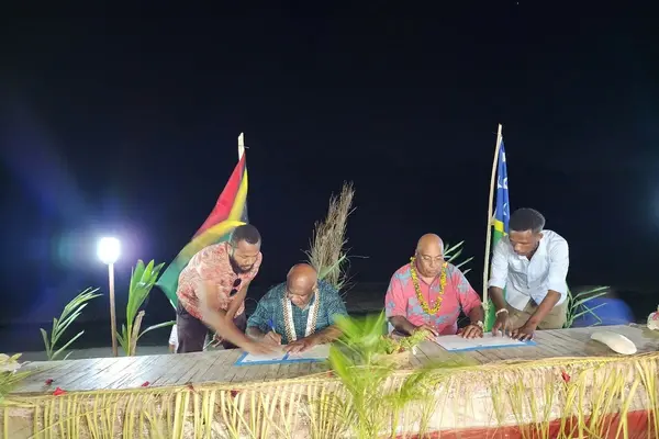 Permanent Secretary of the Ministry of Foreign Affairs and External Trade, Collin Beck signing the outcome document with the head of the Vanuatu delegation, Director General of Vanuatu’s Ministry of Foreign Affairs, International Cooperation and External Trade, Kalfau Kaloris.