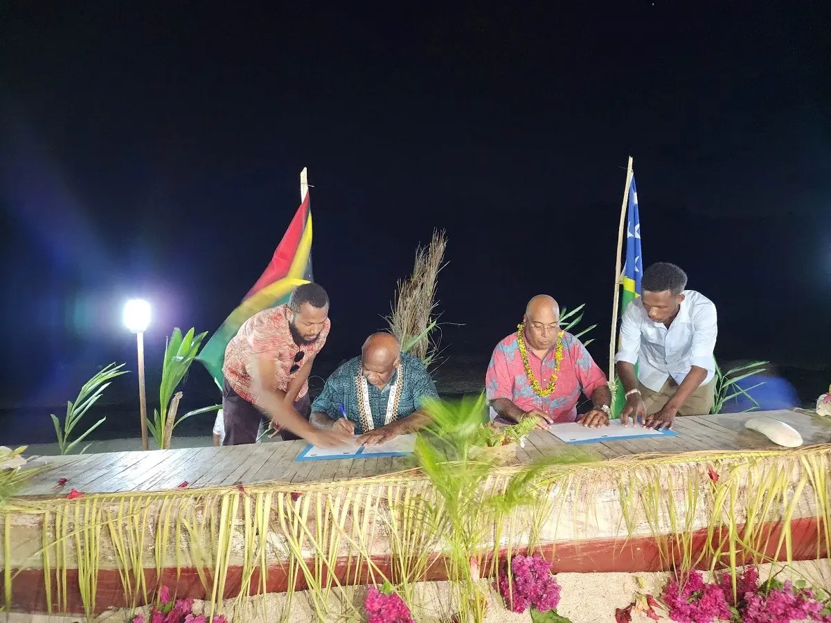 Permanent Secretary of the Ministry of Foreign Affairs and External Trade, Collin Beck signing the outcome document with the head of the Vanuatu delegation, Director General of Vanuatu’s Ministry of Foreign Affairs, International Cooperation and External Trade, Kalfau Kaloris.