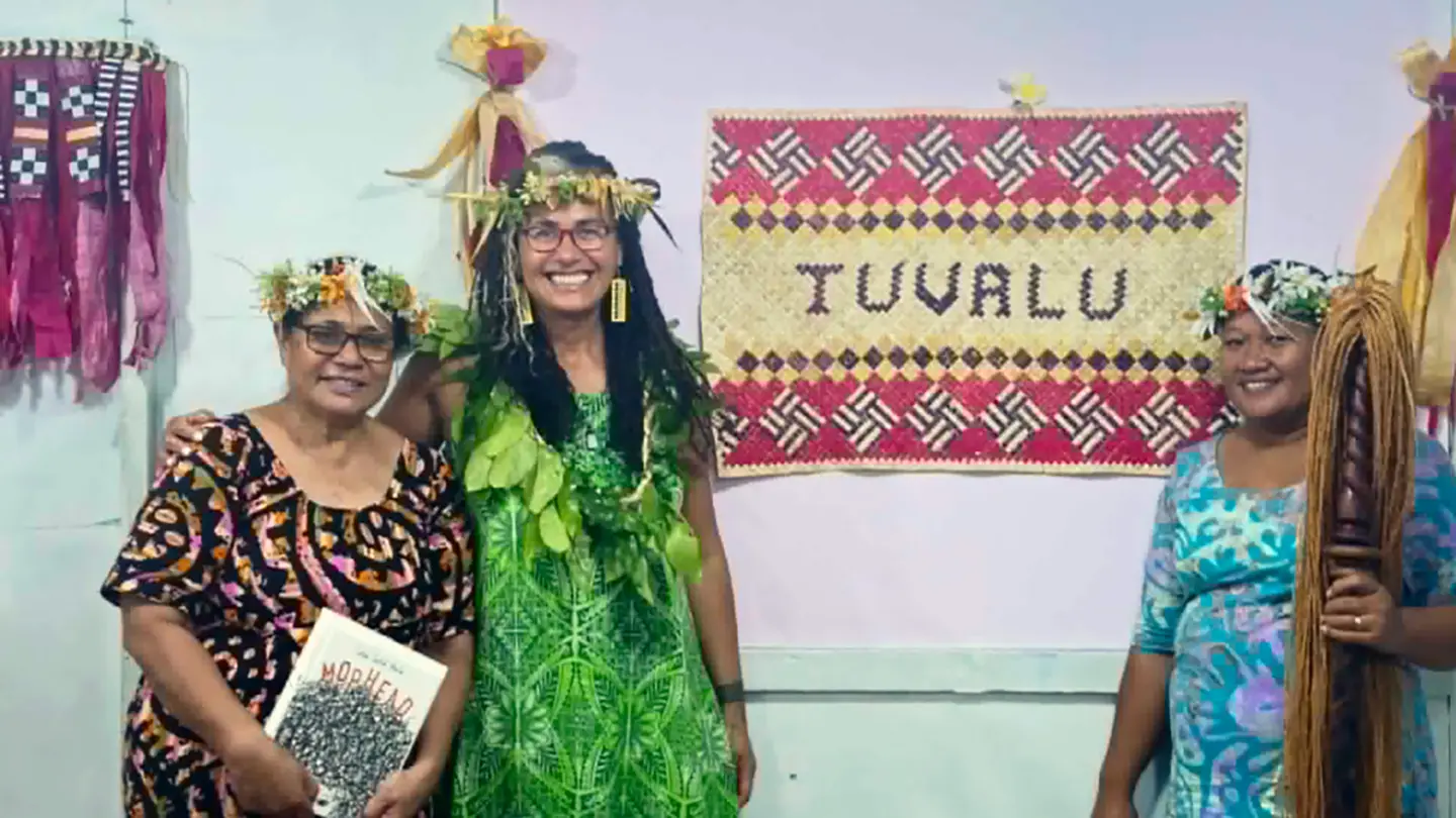 Selina Tusitala Marsh, centre, at a workshop in Tuvalu with a copy of her book Mophead