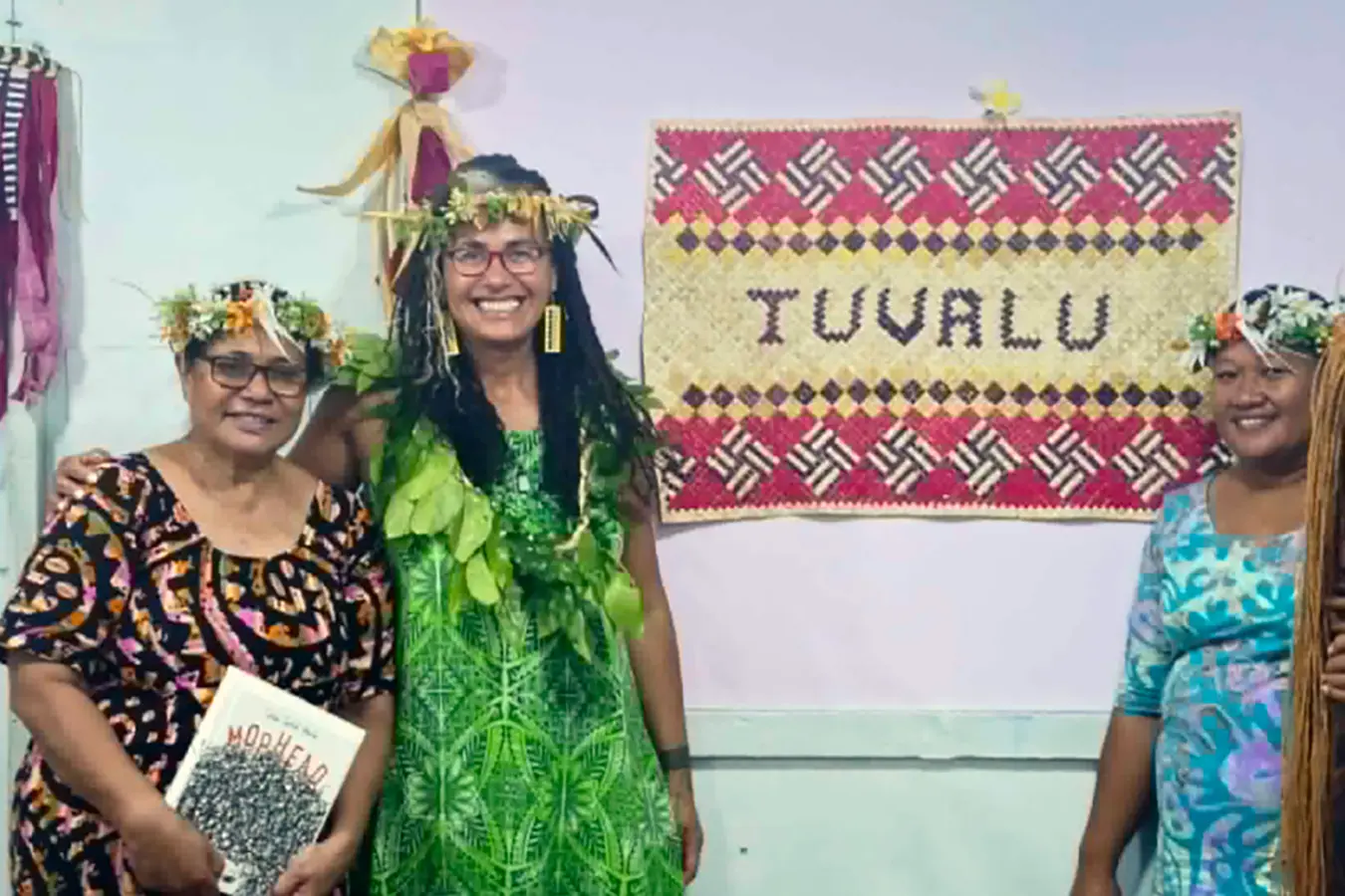 Selina Tusitala Marsh, centre, at a workshop in Tuvalu with a copy of her book Mophead
