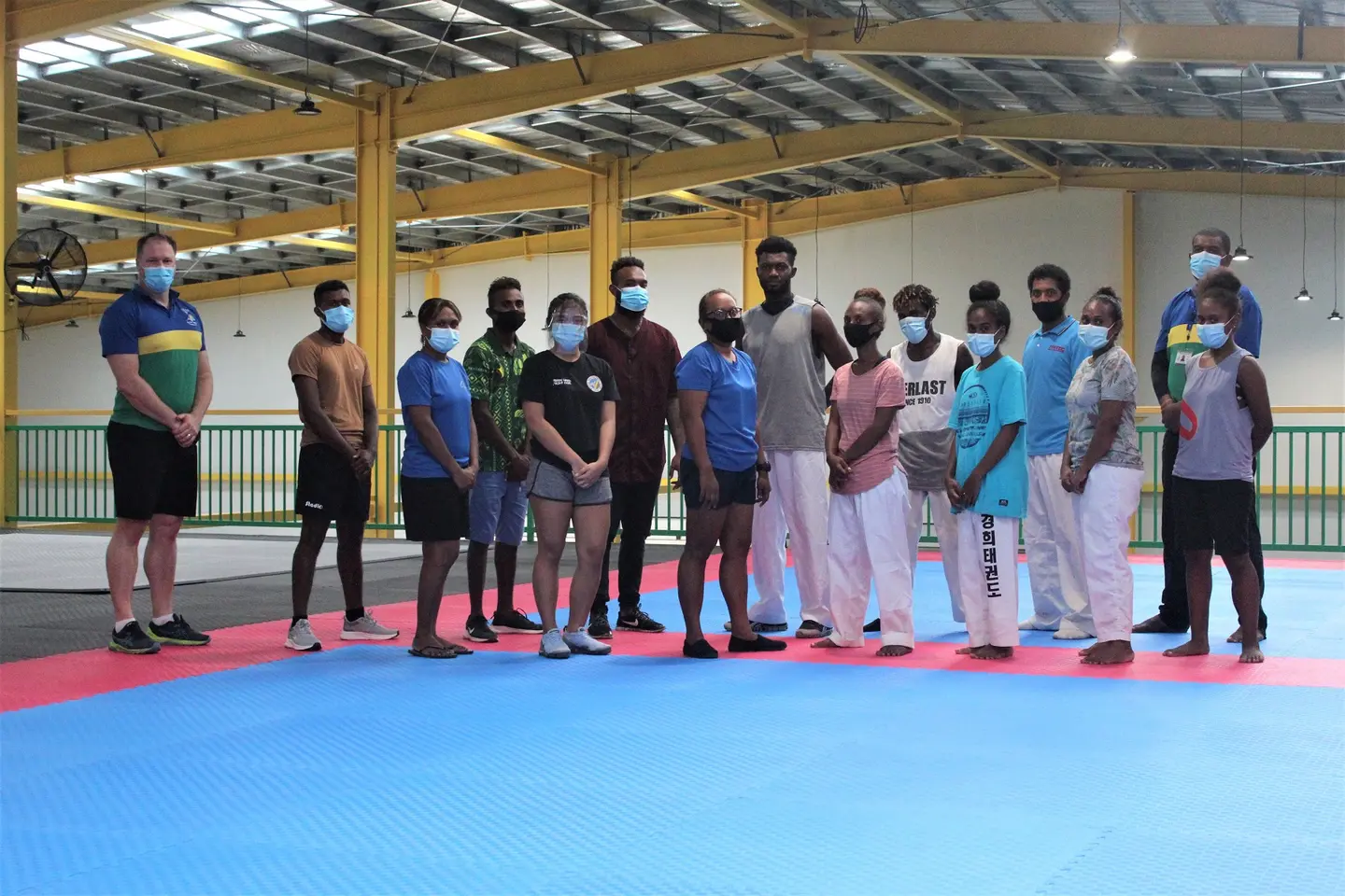 SIWTU training squad flanked by SINIS Executive Director Aaron Alsop & Portfolio 1 Manager Moses Aunama Jr.