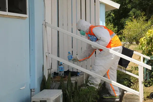 A front-line officer supplying water to one of the rooms at the GBR quarantine centre.