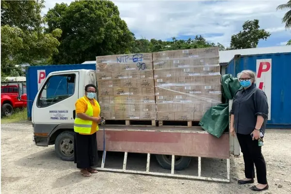 Permanent Secretary of Ministry of Agriculture and Livestock, Ethel Tebengi Frances and Acting Australian High Commissioner, Sally-Anne Vincent with food supplies for communities in Honiara.