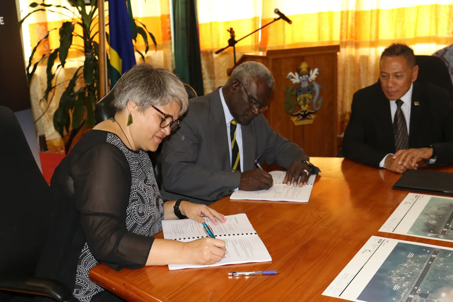 Hon. Prime Minister and the New Zealand High Commissioner at the signing ceremony, witnessed by the Minister for Aviation, Hon. Shanel.