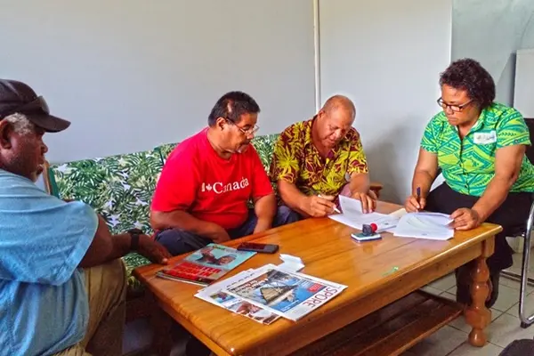 MAL Permanent Secretary Ethel Tebengi Frances and Chairman of SIPFA John Kwaita signs the MoU as reps from MAL and SIPFA watches in witness.