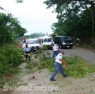 Police clearing up road blocks East of Honiara.