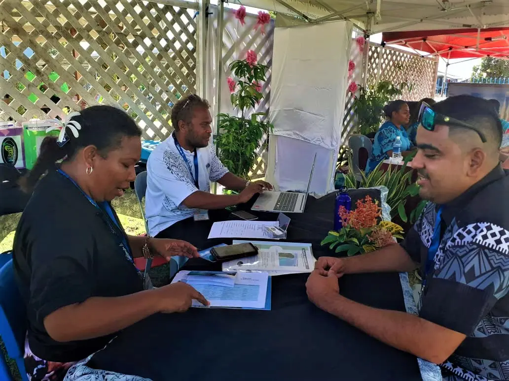 Strongim Bisnis Senior Business Advisor James McGoon at a booth talking with one of the 28 tourism operators.