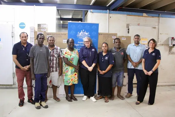 A group photo taken during the handover of the largest single delivery of vaccine doses to arrive in Solomon Islands to date.