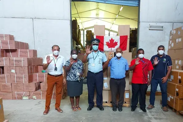 Group photo with consignment of face masks. L-R Dr Yogesh Choudhri MHMS Senior Advisor, Mrs. Pauline McNeil, MHMS Permanent Secretary, Mr. Mostyn Mangau Police Commissioner, Hon. Dr Culwick Togamana Health Minister, Cornelius Walegera Deputy Secretary Foreign Affairs and Wesley Kukutu Manager National Medical Store.