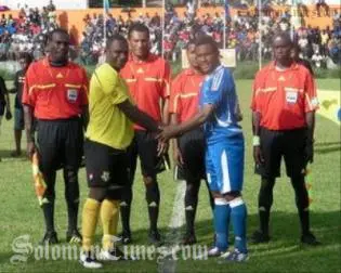 Opposing captains Jean-Robert Yelou, left, and Henry Fa'arodo exchange pleasantries before the match.