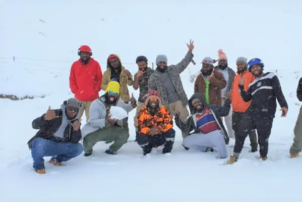 Transferred workers enjoying the snow on their road trip.