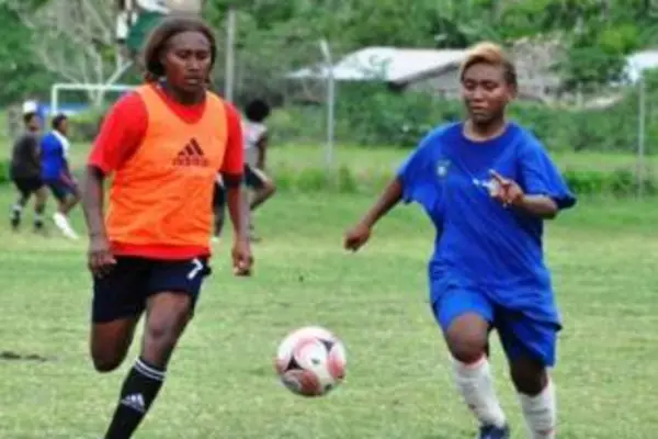 Rose Gwali (L) competes with Joy Timo of Honiara Select for the ball.