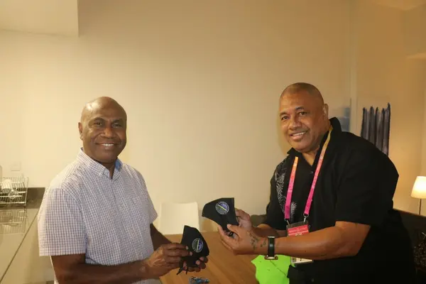 Commissioner General Ambassador, Moses Kouni Mose and Communications Volunteer, Mr. Kelepi Abariga display customized Solomon Islands face masks at the Solomon Islands Pavilion.